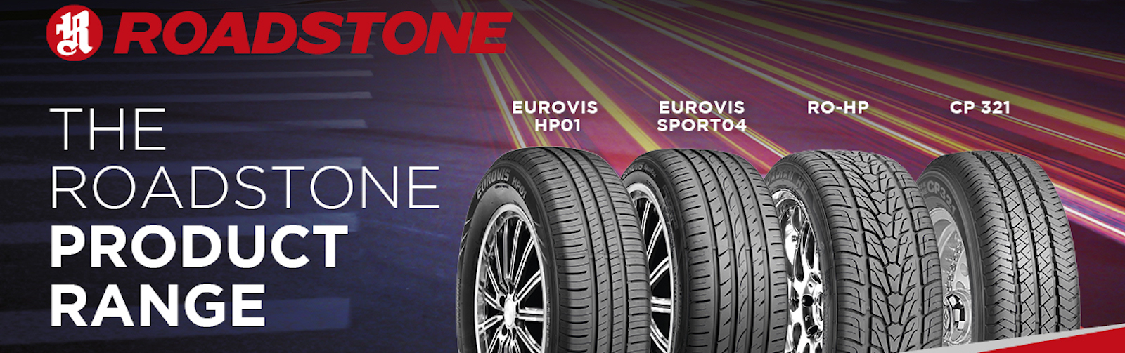 Close up of four Roadstone tyres standing upright on the road